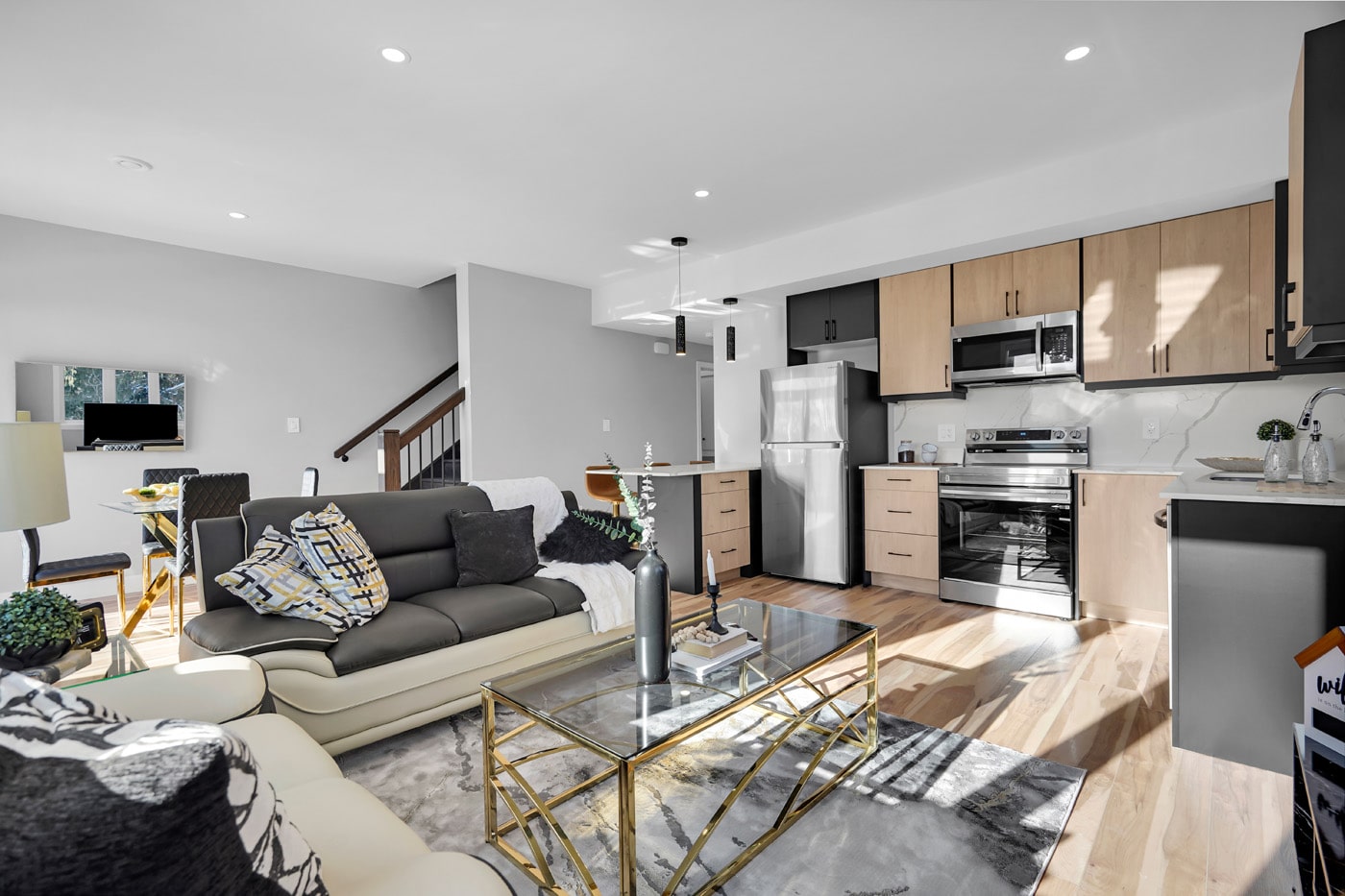 Furnished open-plan living room and kitchen at Nova Residences
